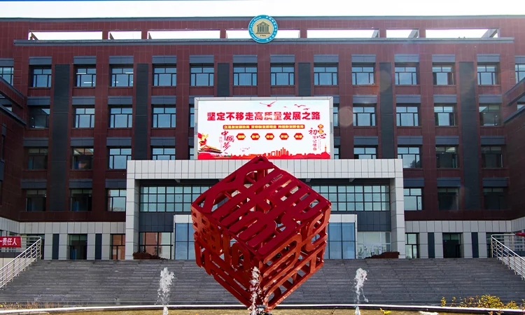 Корпус и школьная эмблема на площадке колледжа